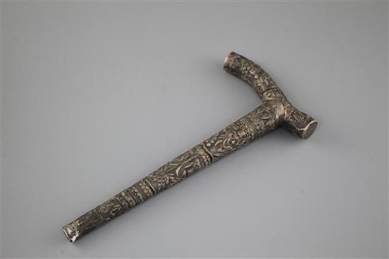 An Indian? embossed white metal cane handle, unmarked, 21.5cm, 2.5oz.